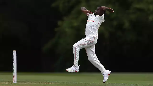 Zimbabwe players celebrate after dominating the opening day of an international cricket match with bat and ball.
